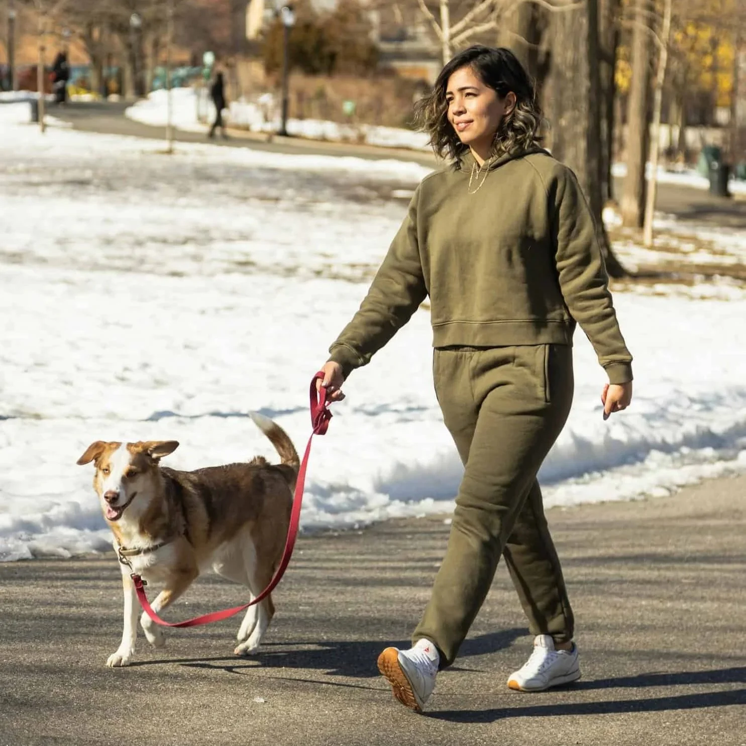Woman walks her dog to increase movement and maintain good circulation