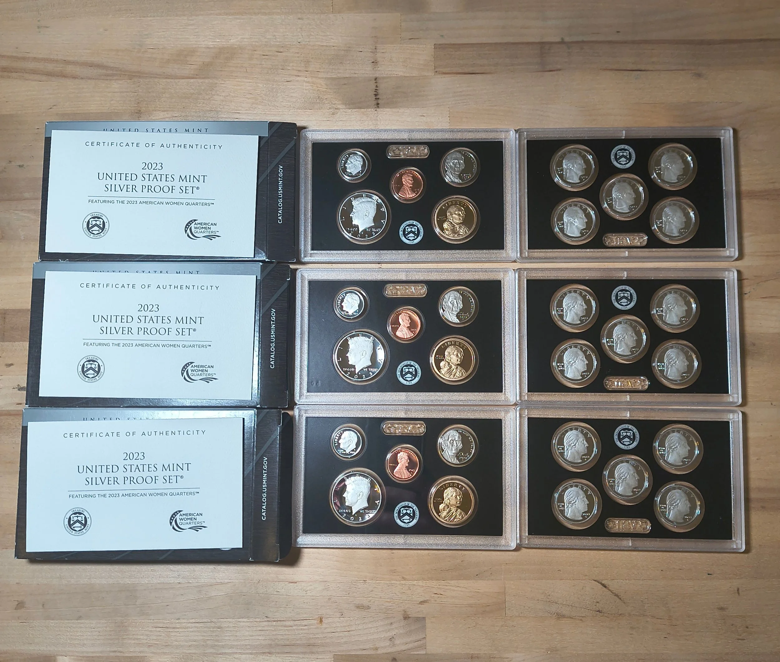Three sets of 2023 American Silver Proof quarters with certificates of authenticity, each set containing multiple quarters in protective cases.
