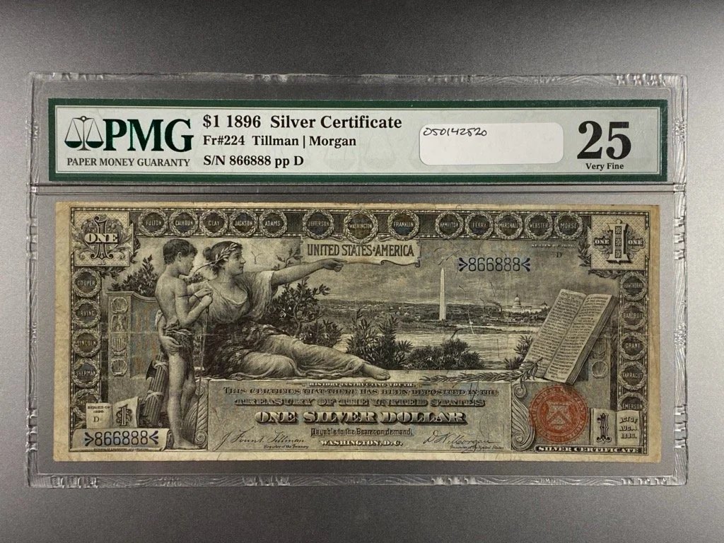 A 1896 United States one-dollar silver certificate banknote in a protective plastic case, graded 25 Very Fine by PMG.