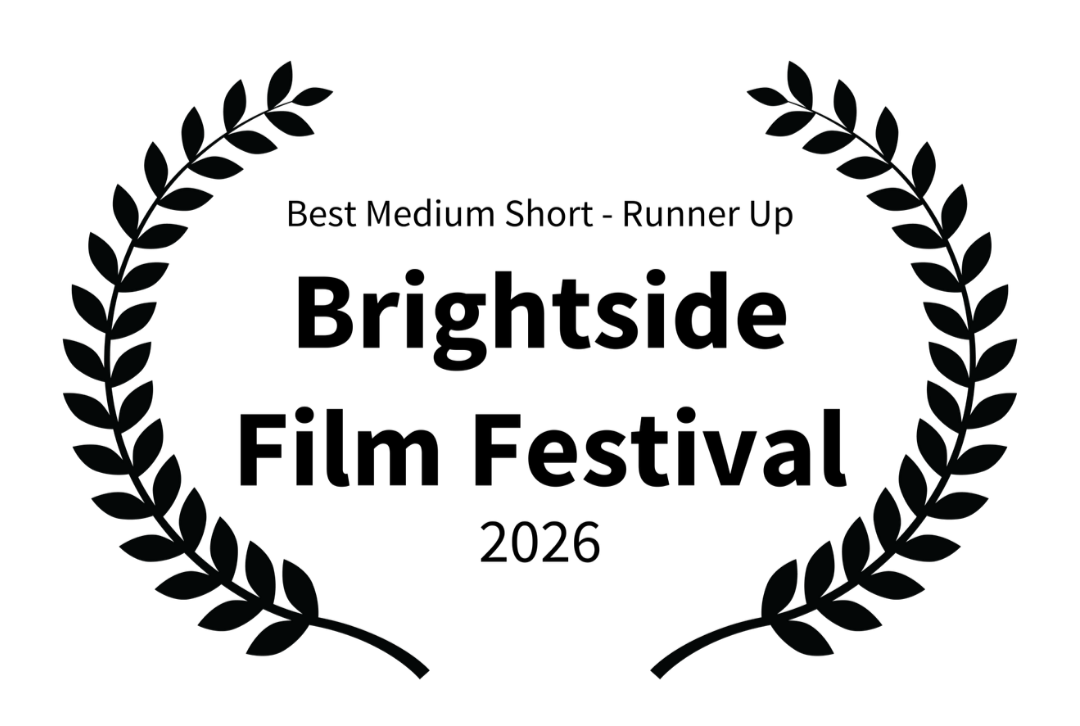 A black background with a circular laurel wreath design.