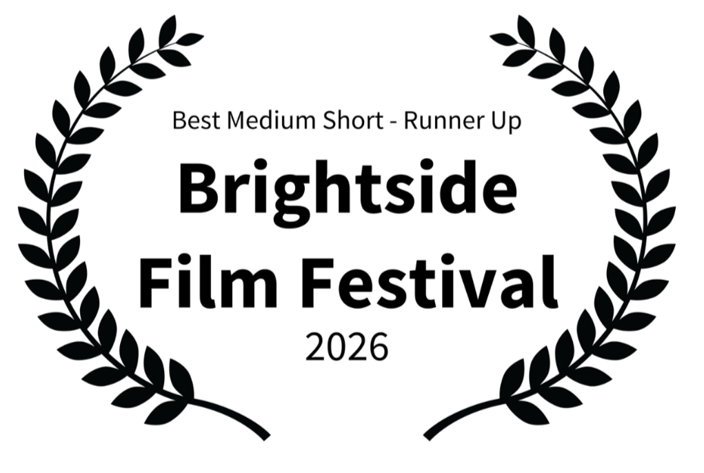 A black background with a circular laurel wreath design.