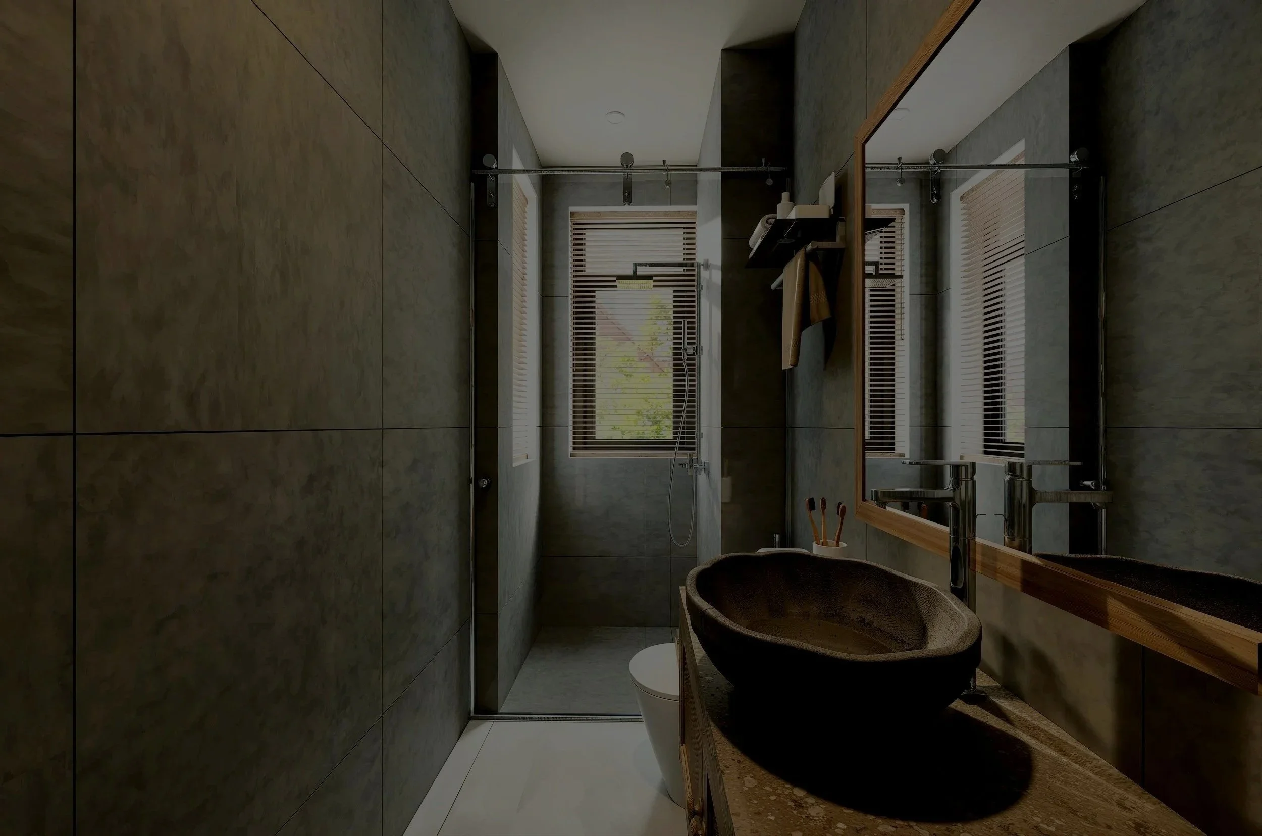 Small modern bathroom with greenish-gray tiled walls, a walk-in shower with a window and blinds, a wooden framed mirror, a black vessel sink on a marble countertop, and a white toilet.