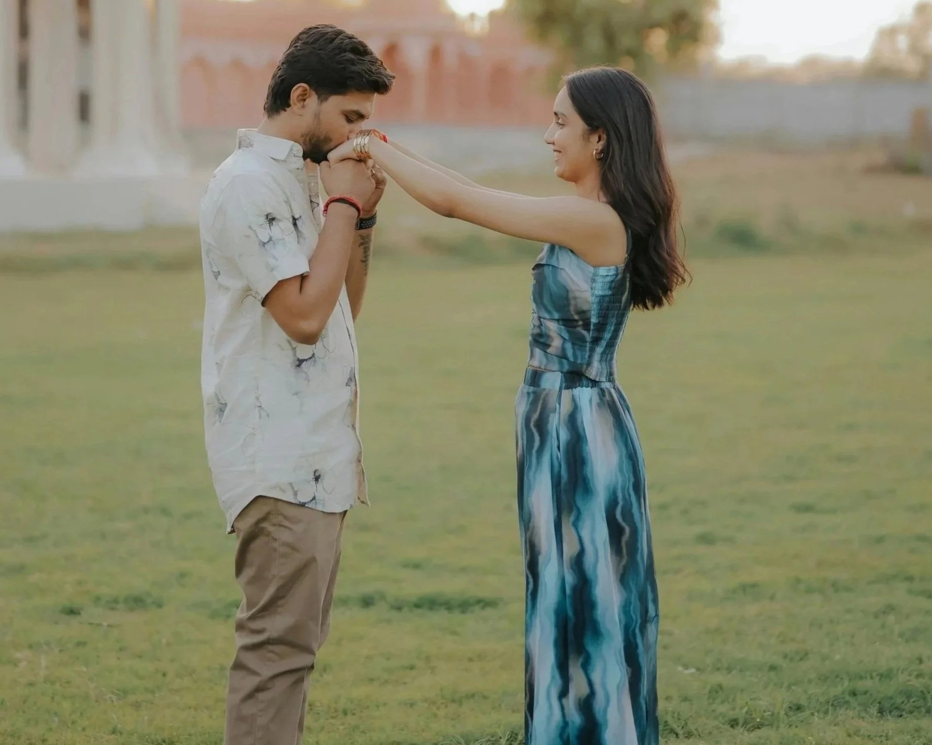 Engaged couple sharing a tender moment outdoors at golden hour