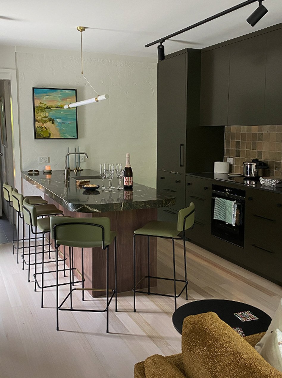 Modern apartment kitchen in Little Malop Street, Geelong featuring dark cabinetry, stone island and integrated appliances by Geelong Building Co.