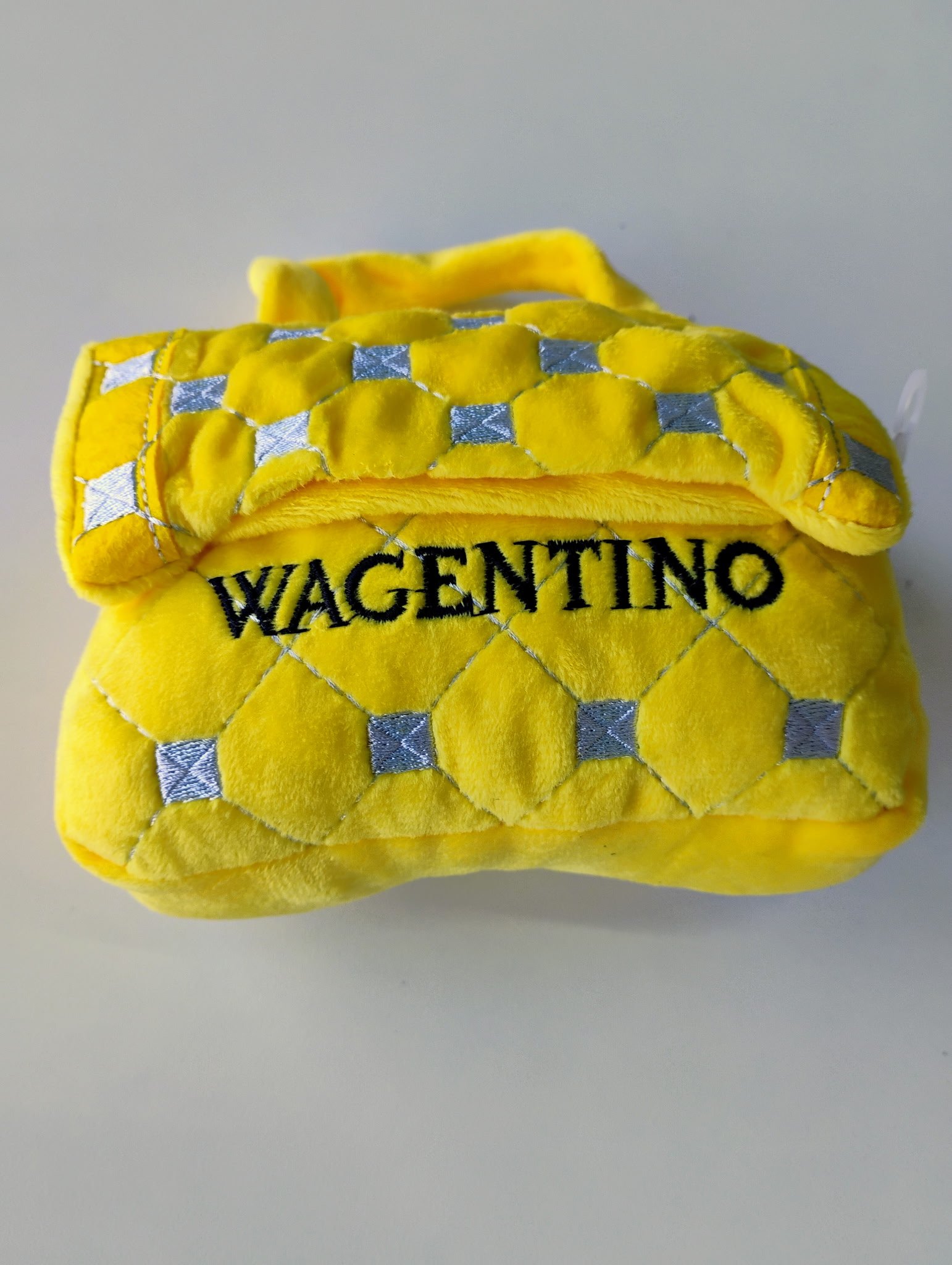 Yellow velvet pouch with silver diamond patterns and the word "WAGENTINO" embroidered in black.
