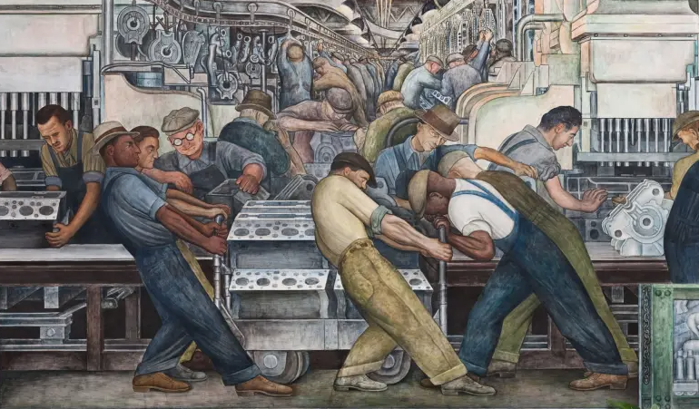 Workers in a factory engaged in manufacturing and assembling machinery, with some pushing a vehicle engine on a cart.