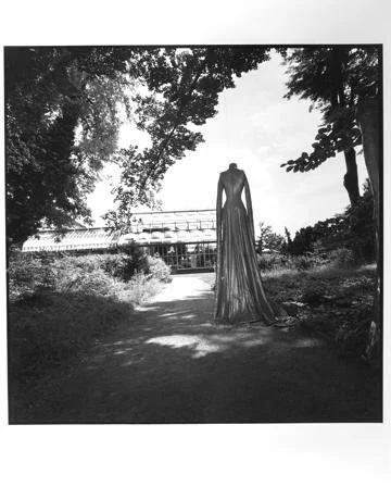 Rosalind Fox Solomon,  Mahon 642 (headless figure with long dress facing a greenhouse),  16" x 16"