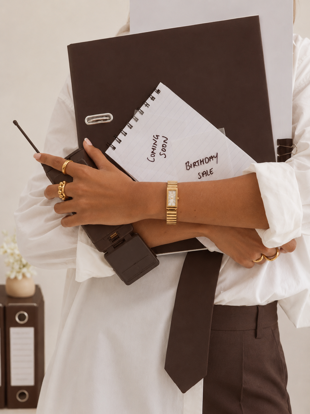 Sociél Muet Atelier Payroll Risk & Operations Consultant, Cheri Joseph, holding a black planner, notepad, and cellphone ready to quietly create a payroll risk prevention plan with a CFO or HR Director