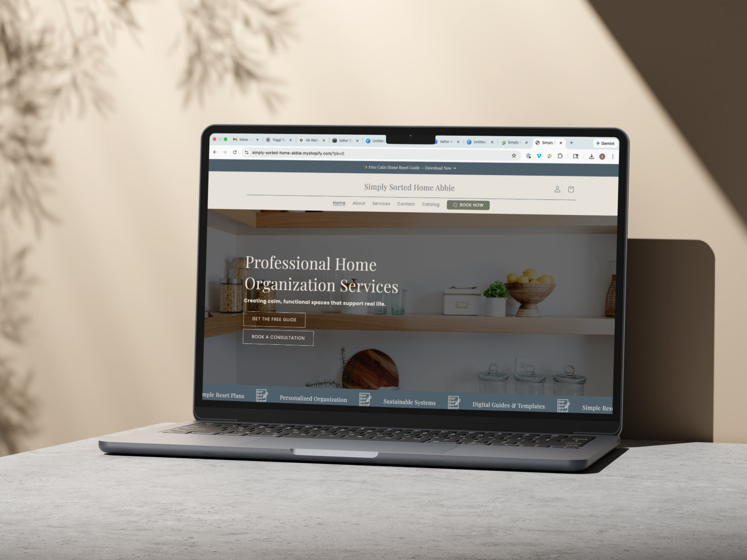 A laptop on a desk displaying a website for professional home organization services.