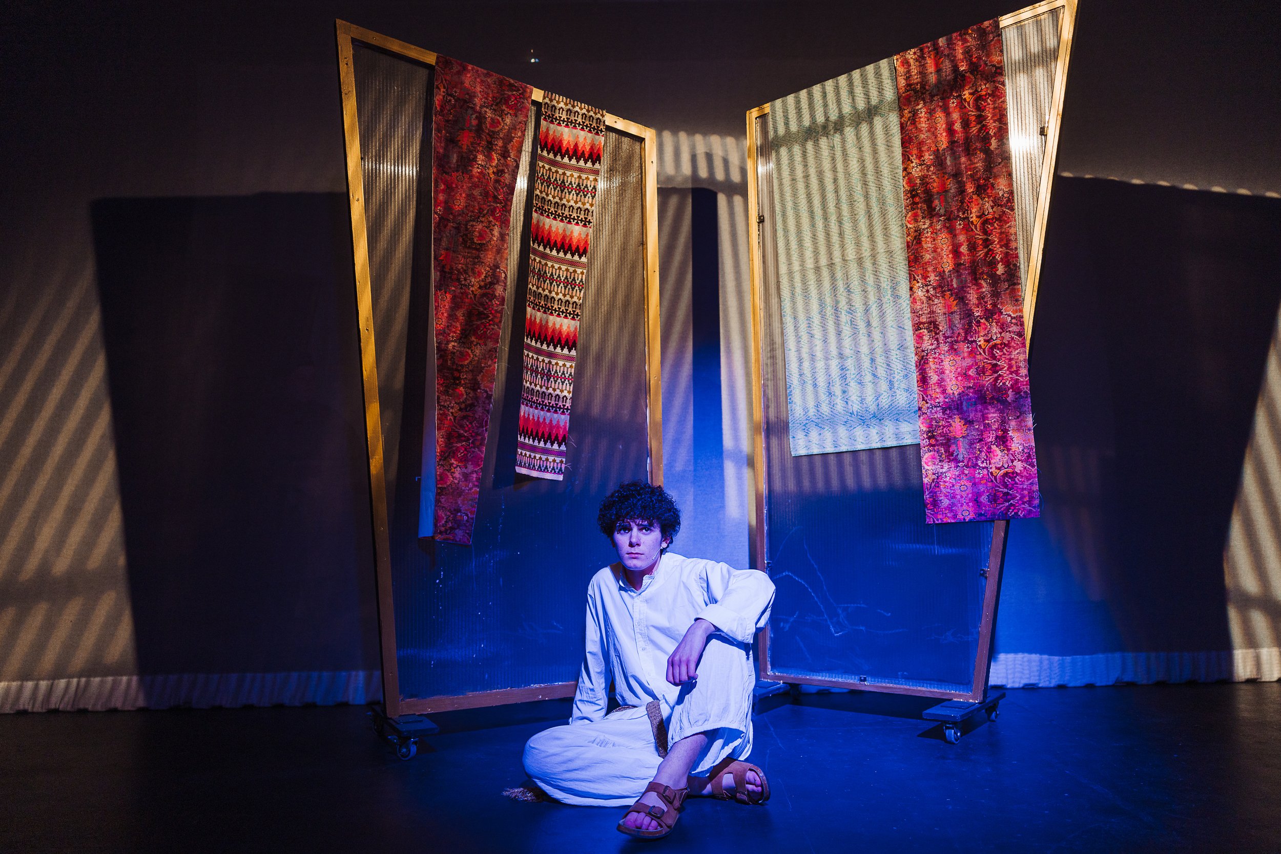 Joseph sitting on the floor in jail during East Broadway's production of Joseph and the Amazing Technicolor Dreamcoat