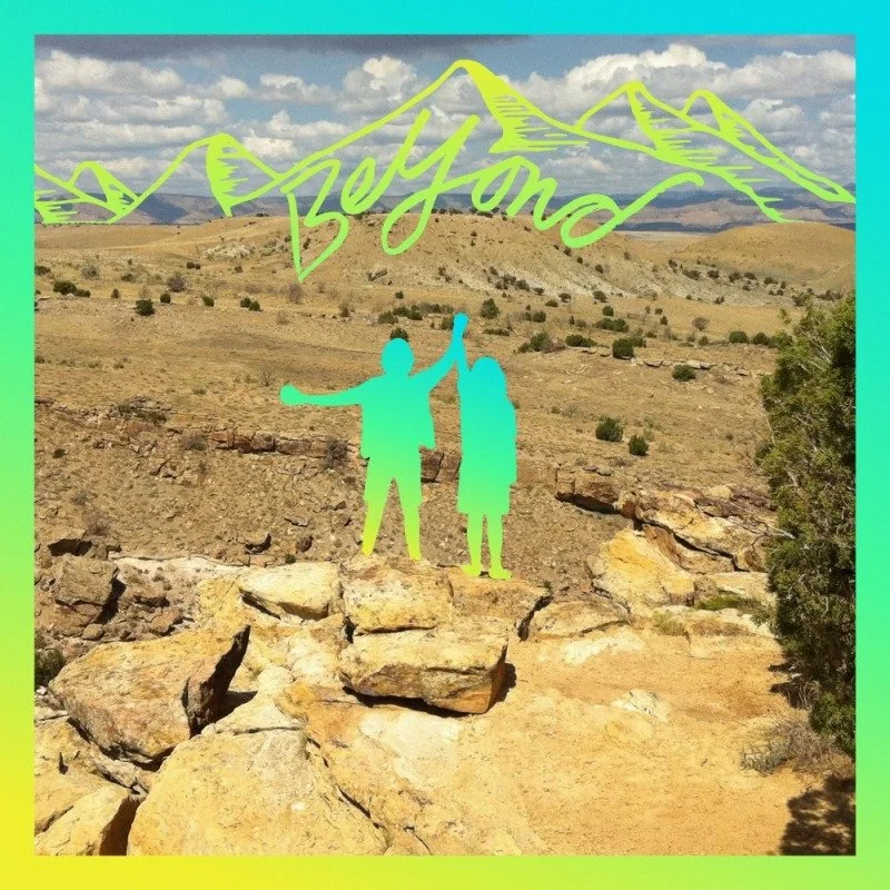 A digital overlay of two people in turquoise, holding hands and raising one arm, with a green mountain outline and the word 'Jeyland' written above, set against a desert landscape background with rocks and sparse vegetation.