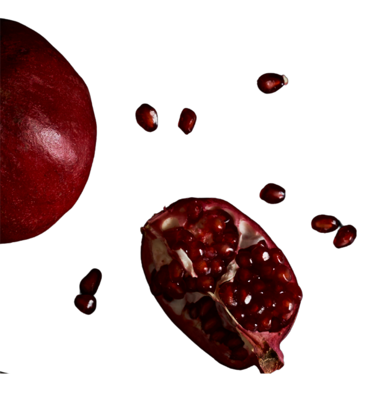 Whole pomegranate and half section showing red seeds on a black background.