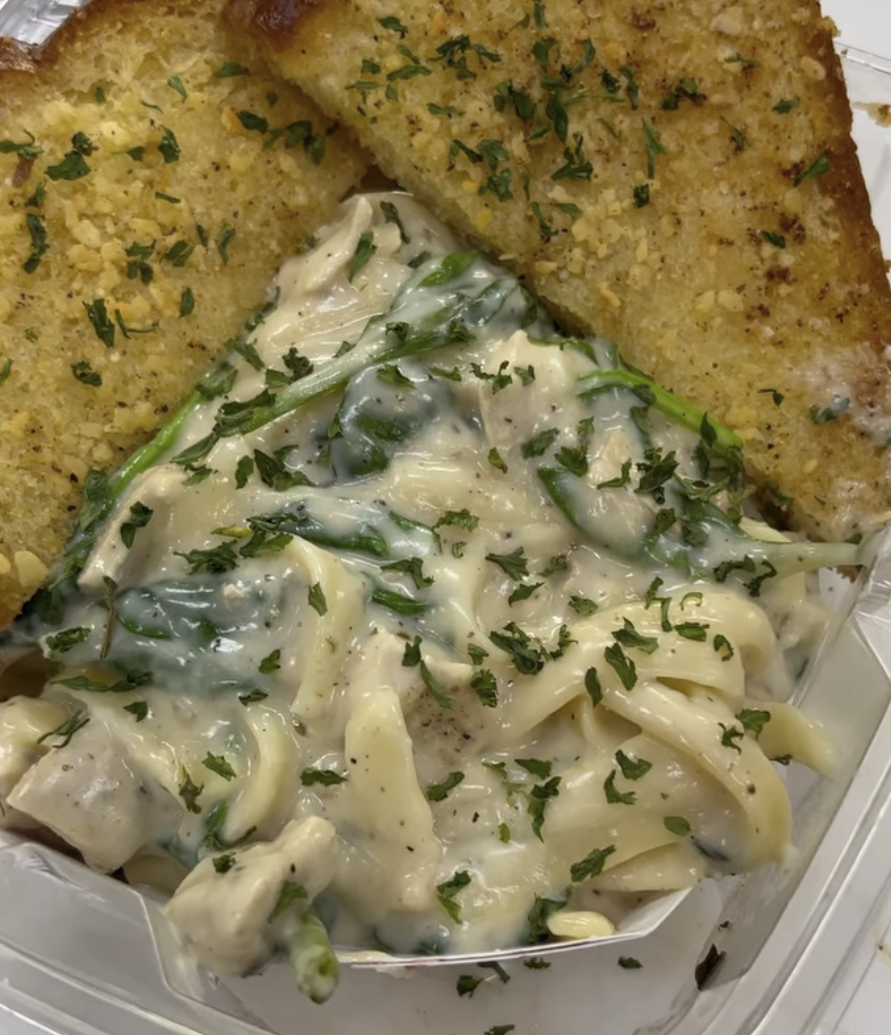 Fried chicken with stuffing and creamy chicken and green bean casserole garnished with chopped parsley.