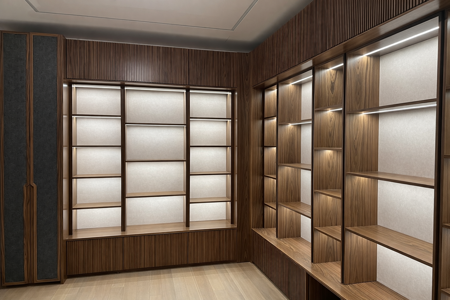 Wooden built-in shelves with soft lighting inside a modern interior room