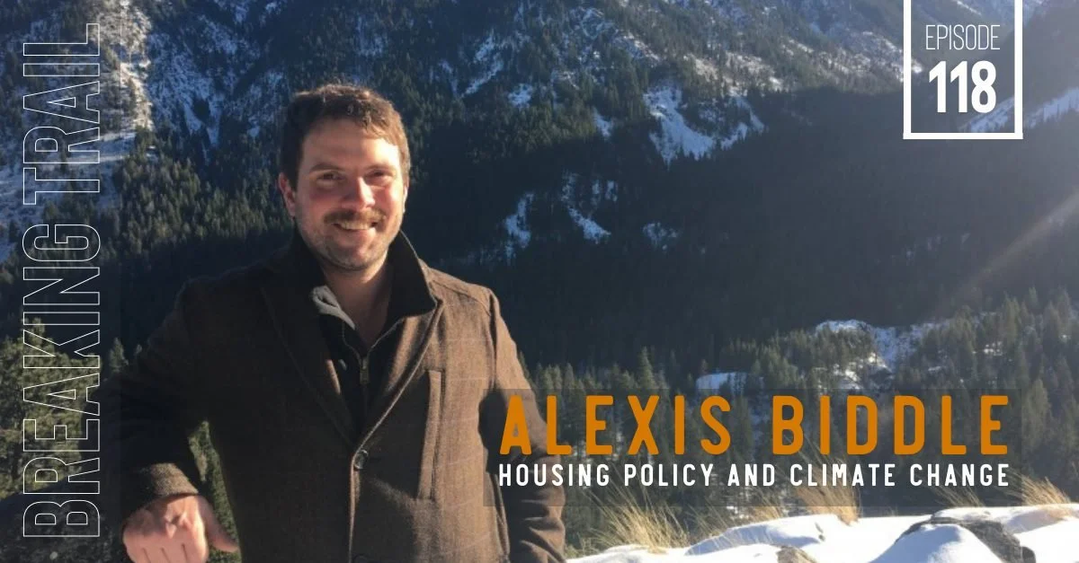A man standing outdoors in front of snow-covered mountains and trees, smiling, with text overlay about a podcast episode on housing policy and climate change featuring Alexis Biddle.
