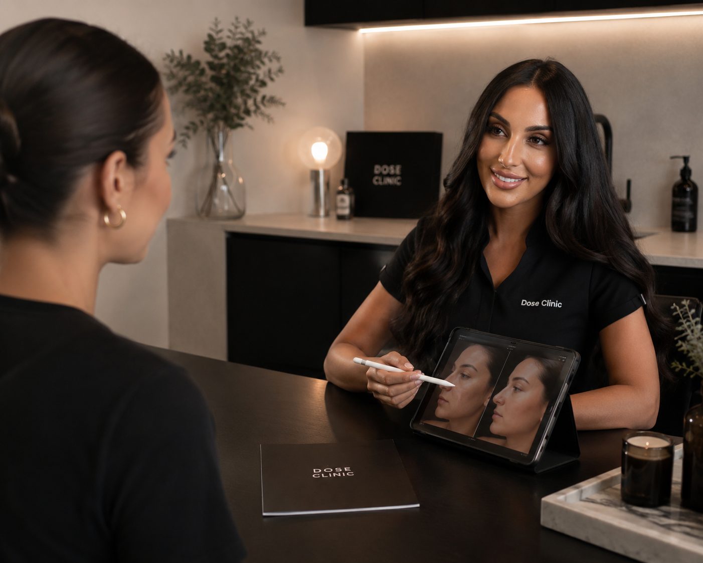 
Woman consulting with professional at Dose Clinic showing tablet:
Personalised skin and scalp consultation at Dose Clinic Brisbane | Science-led treatment planning West Village West End
