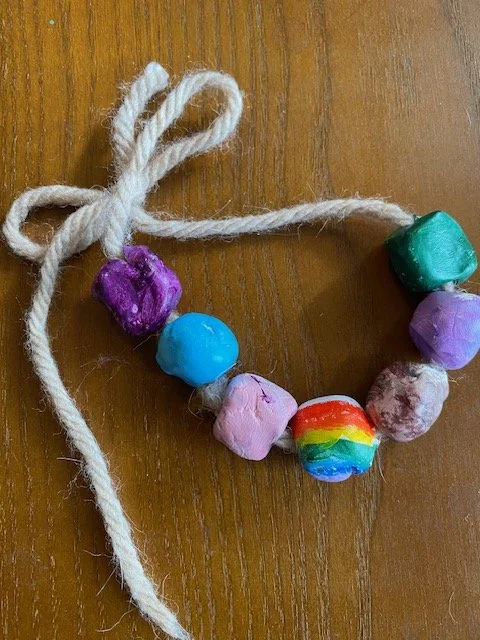 Oven dried clay shaped into beads and painted with acrylic paints.