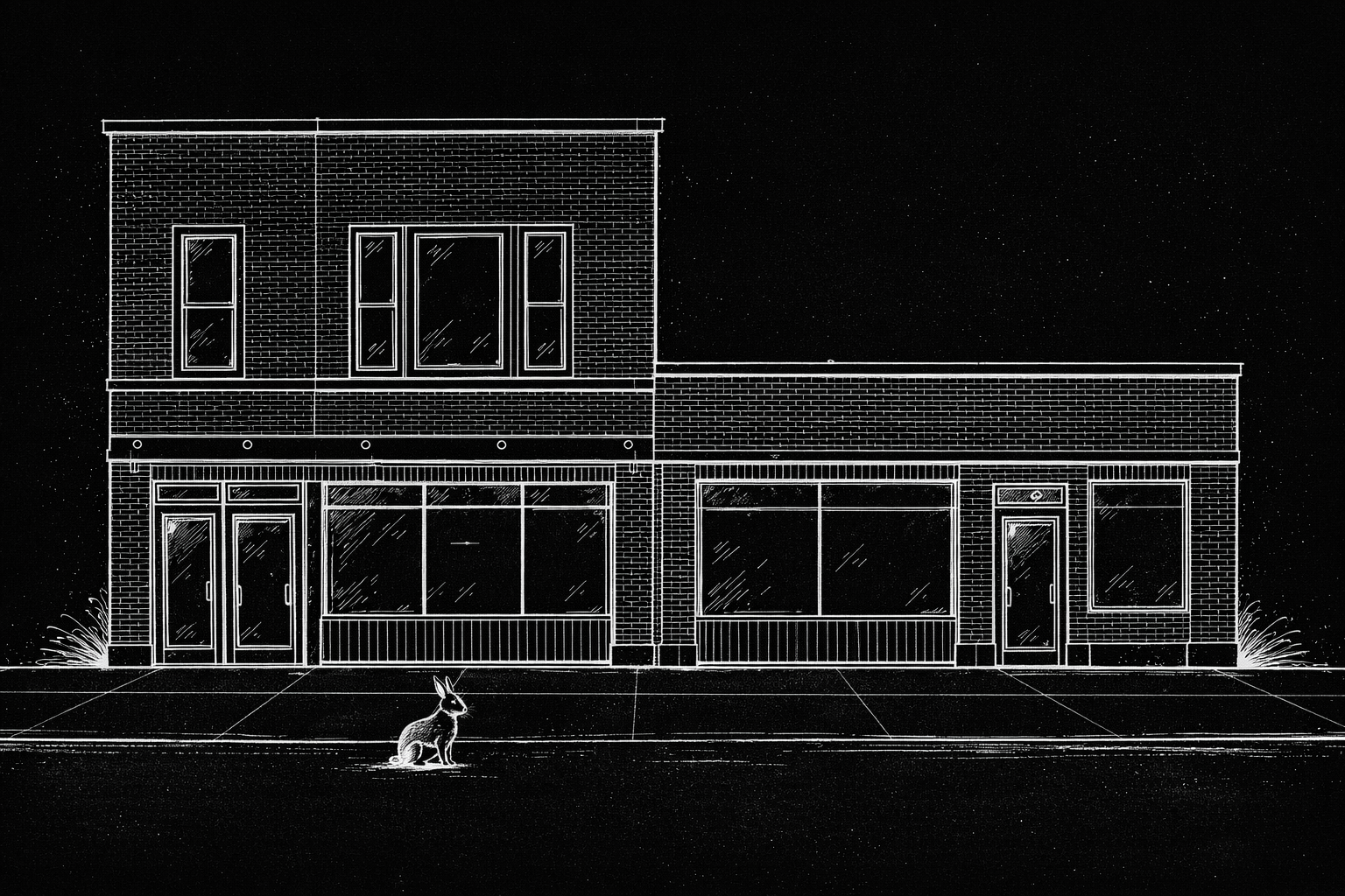 A quiet two-story brick building with large front windows and doors, made to be noticed—and redefined.