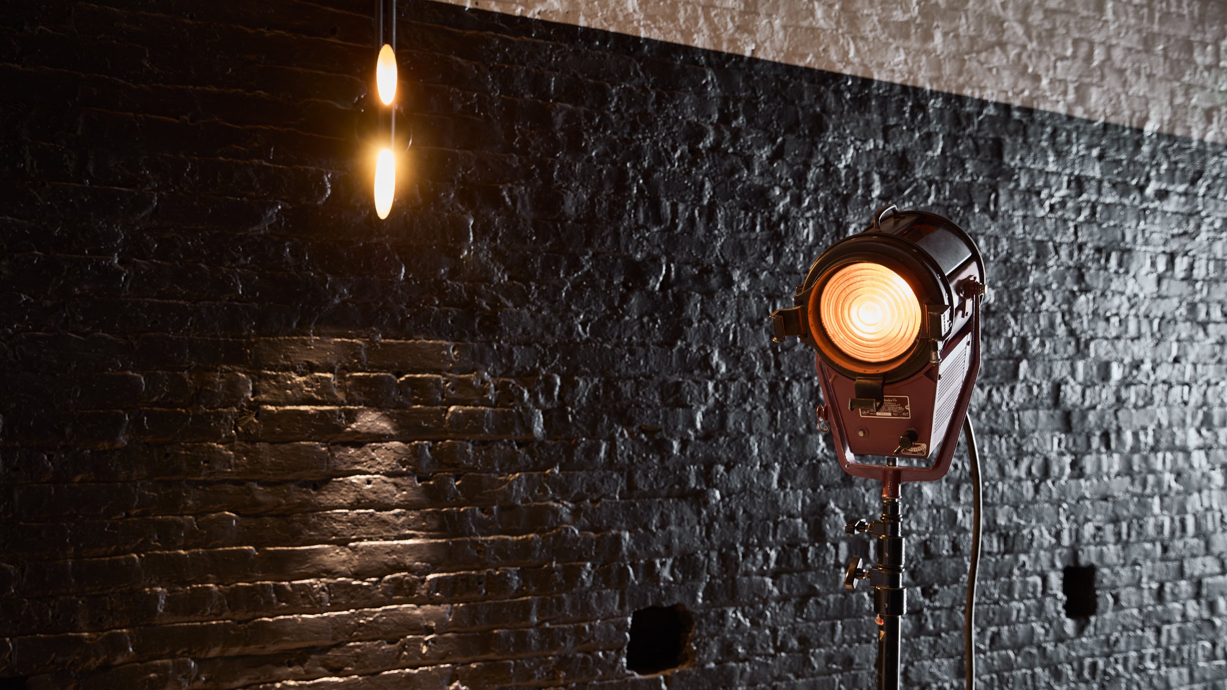 Cinematic lighting and industrial chic design creates a warm creative atmosphere.