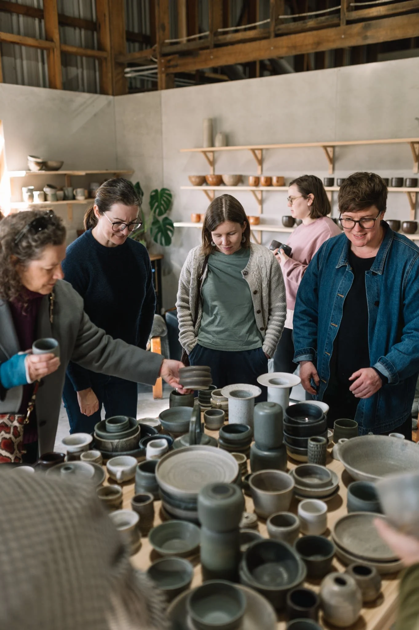 students collecting finished pottery pieces in huon valley studio