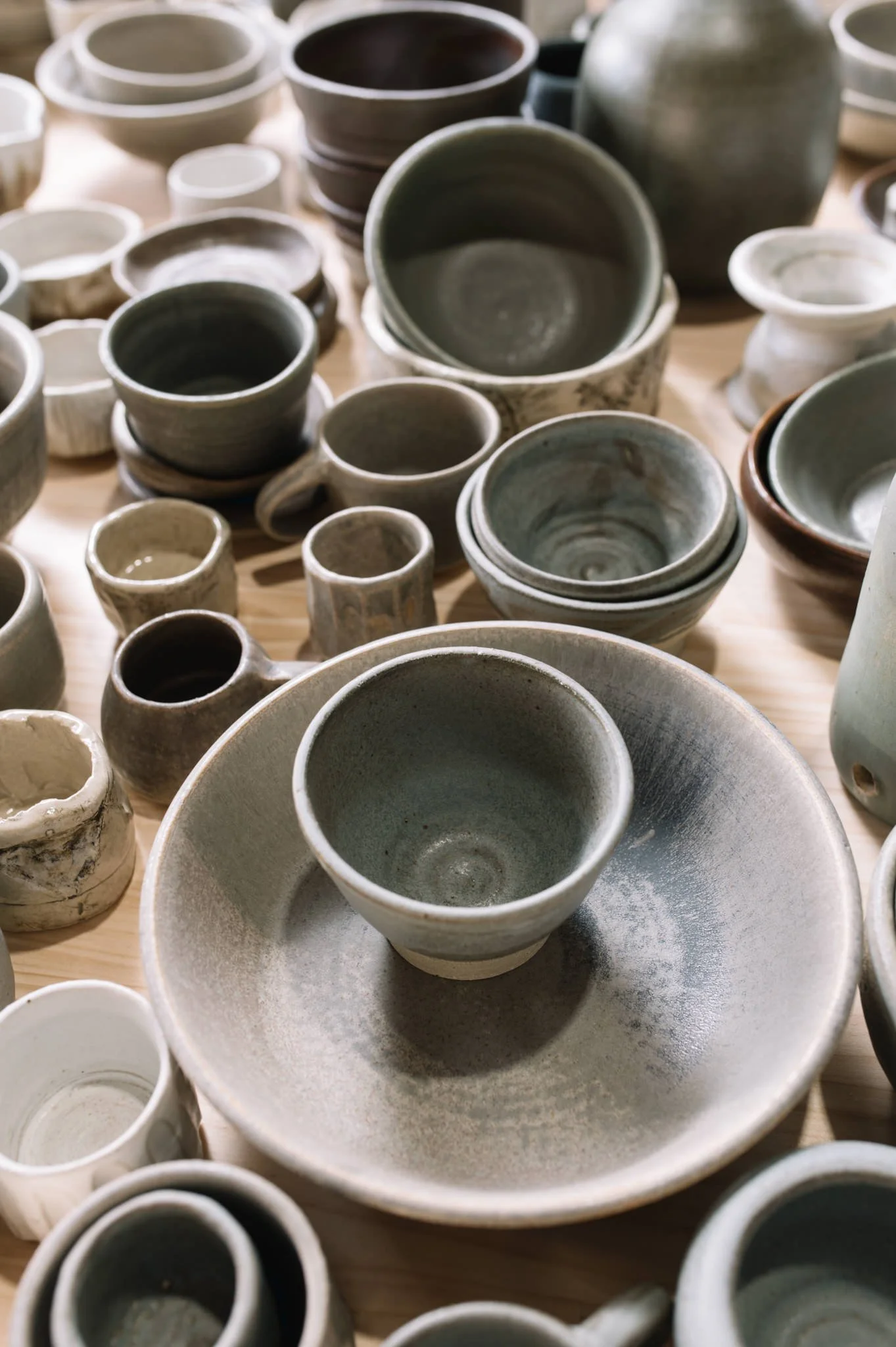 finished handmade ceramics displayed on table in studio