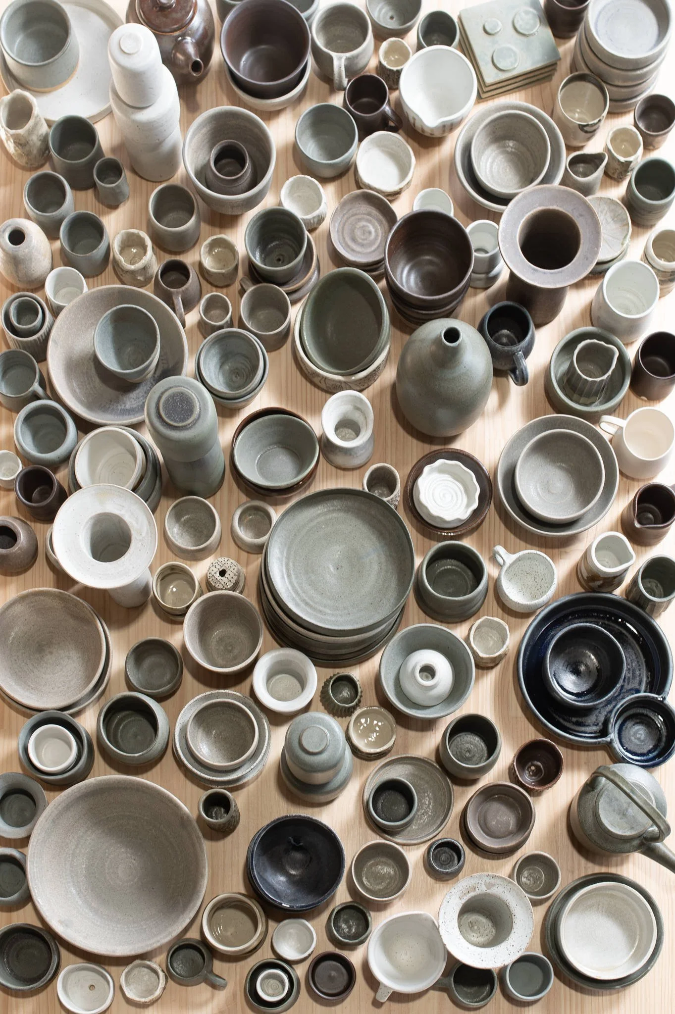Collection of handmade ceramic bowls, cups, and vessels in a pottery studio in the Huon Valley, Tasmania