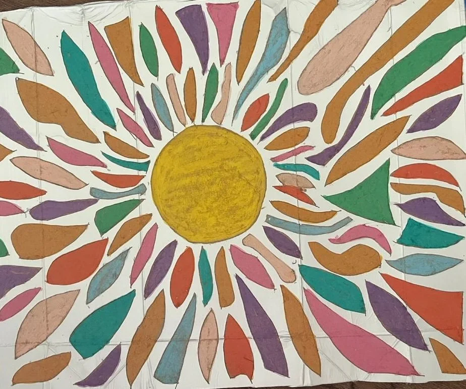 Artwork featuring the sun with rays of different geometric forms and colors