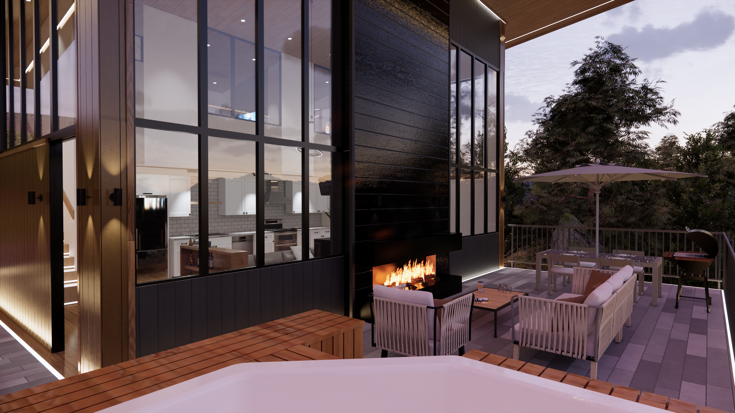 Outdoor patio with a fireplace, seating area with sofa and chairs, dining table with umbrella, view of house interior kitchen through large glass windows, trees, and cloudy sky.