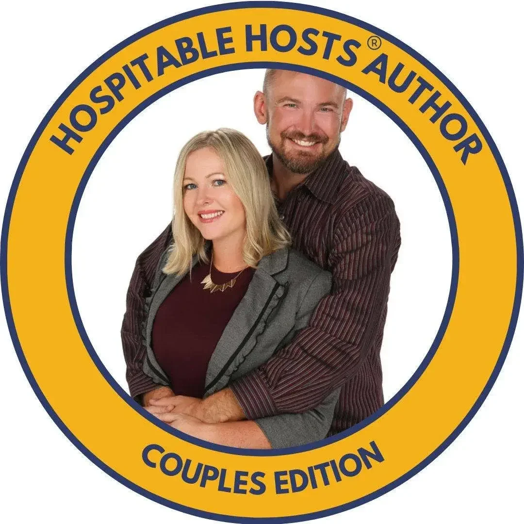 A logo with a circular yellow border that says 'Hospitality Hosts Author' and 'Couples Edition'. Inside the circle, a man and woman are smiling and posing together, with the man behind the woman, both wearing professional attire.