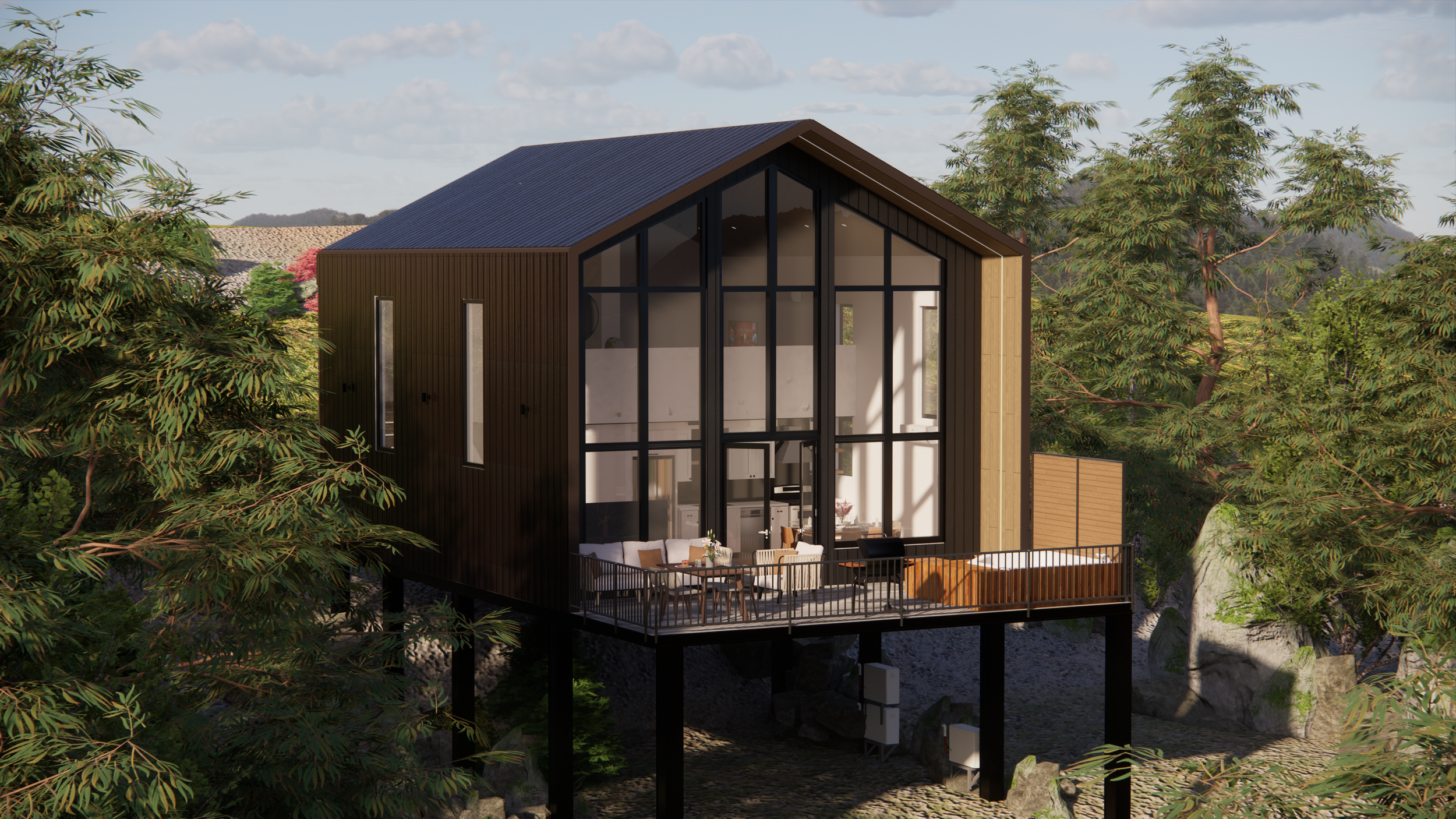 Modern house with large front windows and outdoor patio, elevated on stilts among trees and rocks, with a cloudy sky in the background.