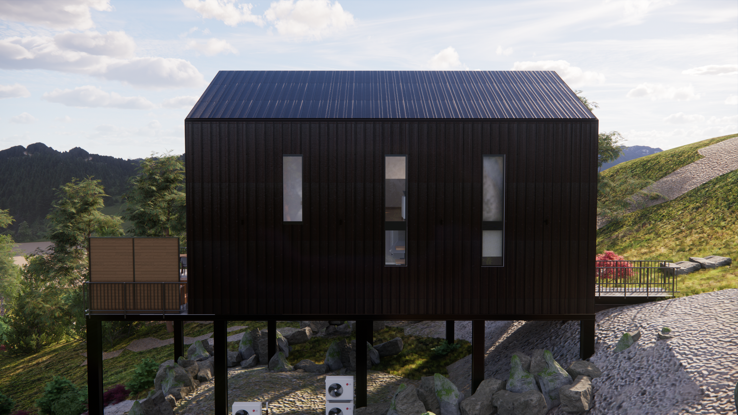 Black modern house elevated on stilts with a blue metal roof, set on a sloped landscape with green hills and mountains in the background, and surrounded by trees and rocks.