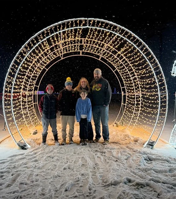 Family standing in the snow