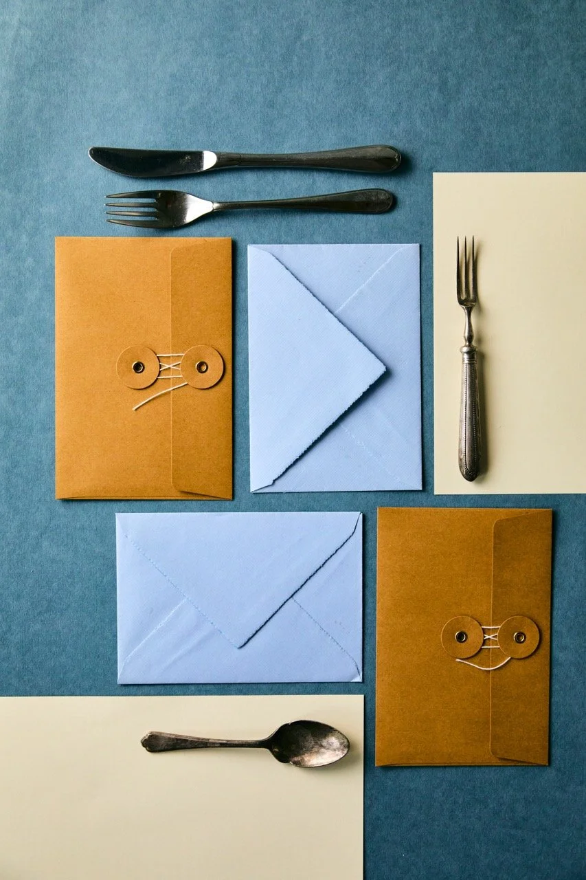 A collage of envelopes, paper and cutlery for eightyfour creative agency.