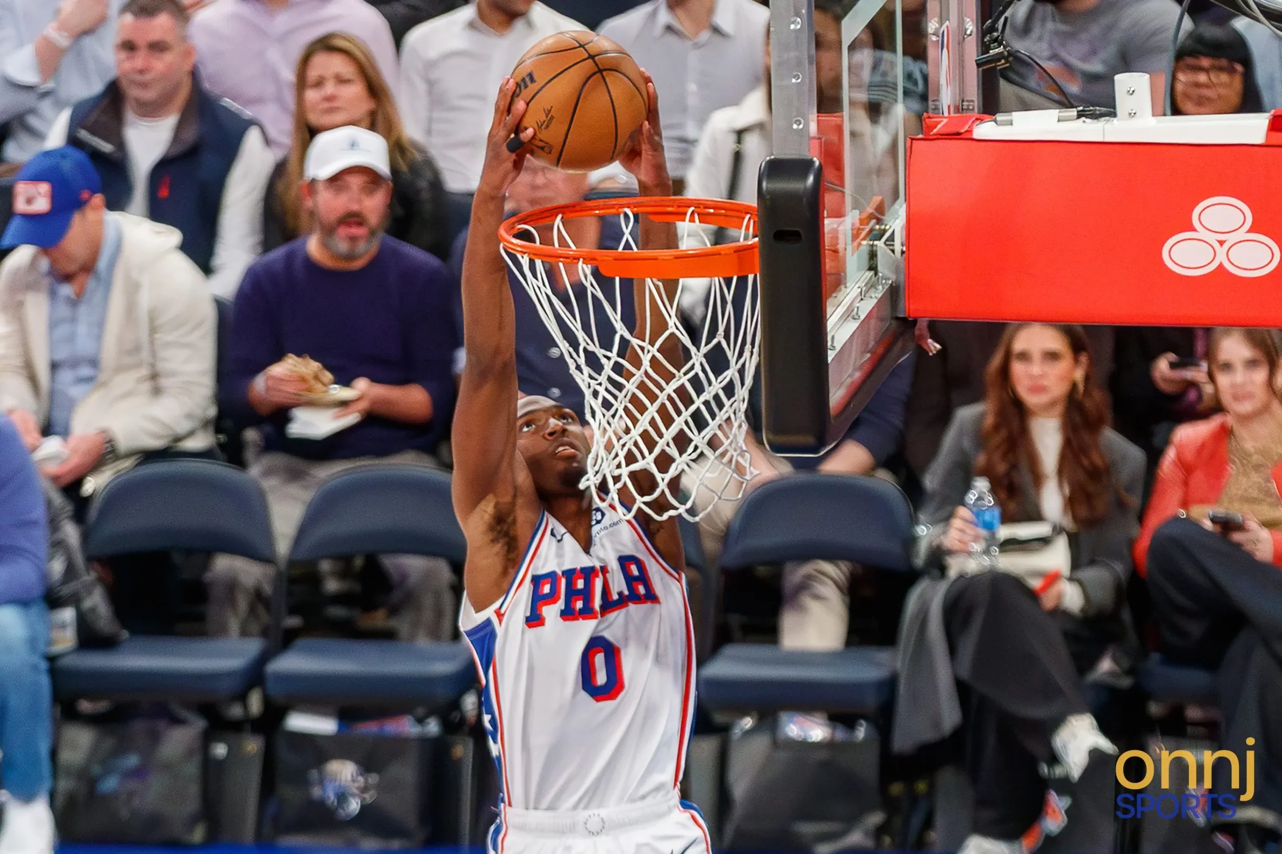 Tyrese Maxey dunking the ball.