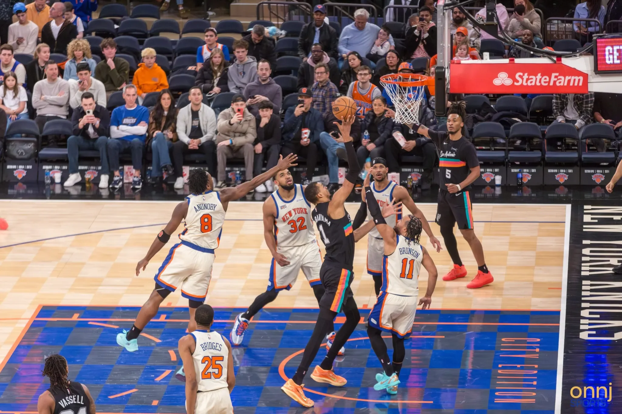 Victor Wembanyama surrounded by Knicks players in the paint.