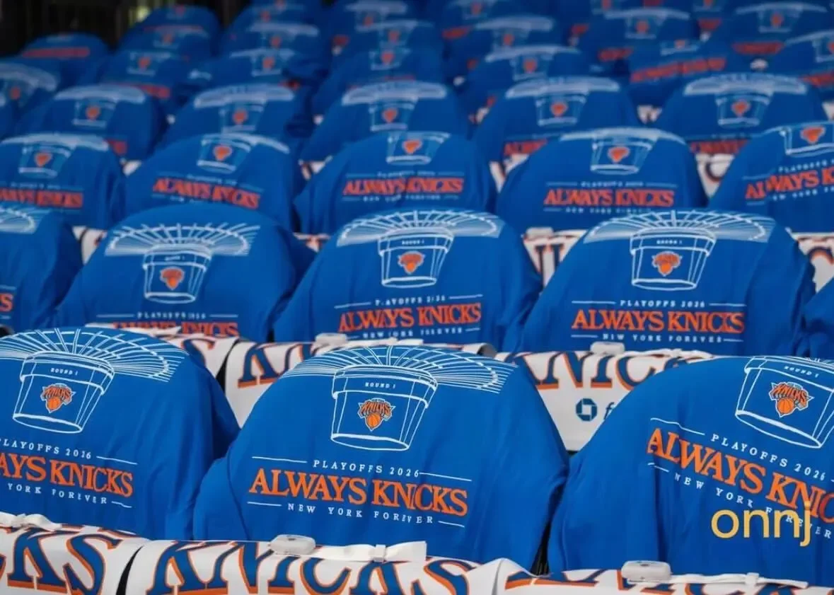 Rows of blue jackets with the New York Knicks logo and text that reads "Playoffs 2026 Always Knicks New York Forever."