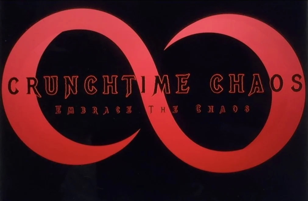 Stylized logo with two red intertwined circles and the text "Crunchtime Chaos" in the center, and the phrase "Embrace the Chaos" below.