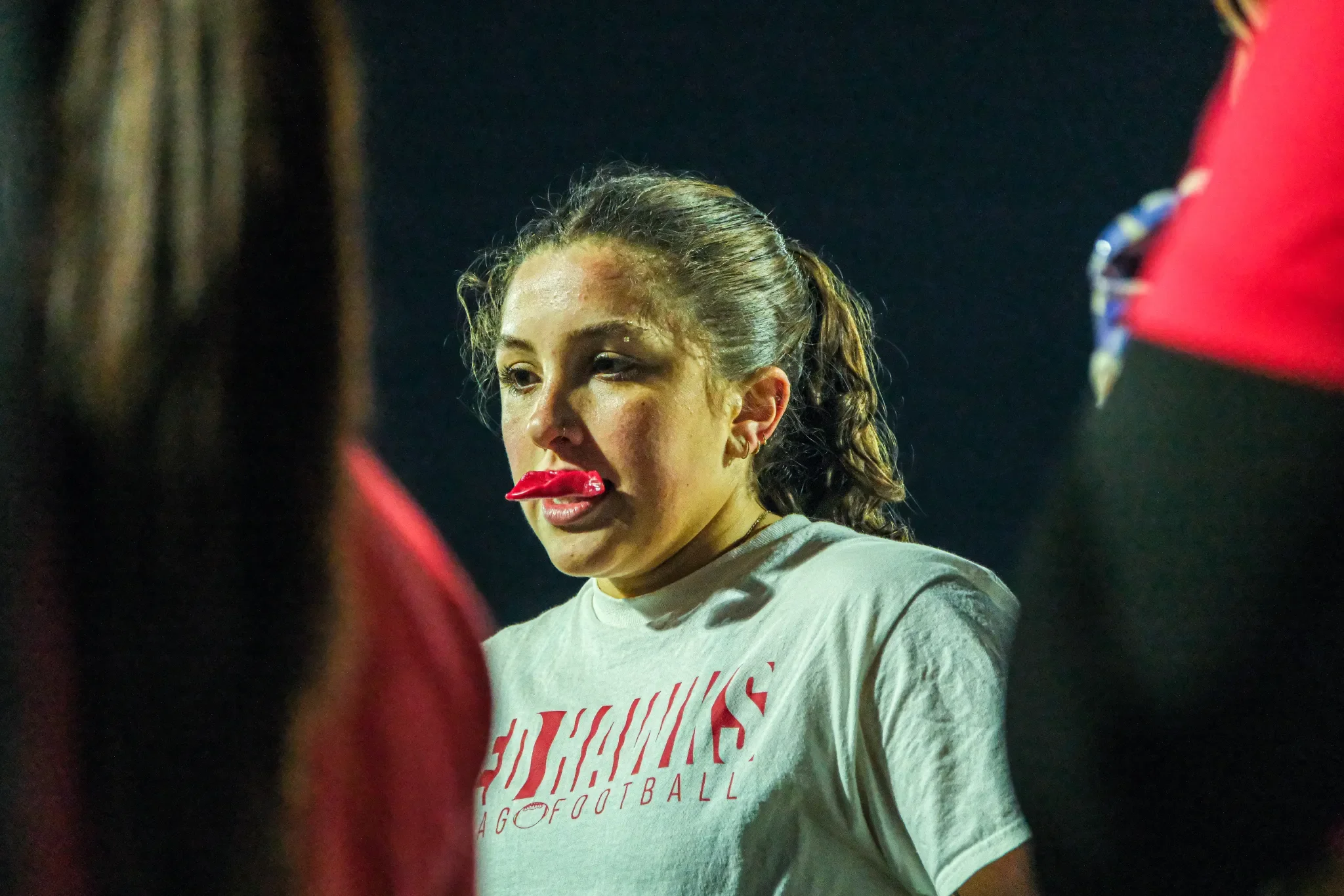 A young woman named Maya Anico in the women's flag football team huddle.