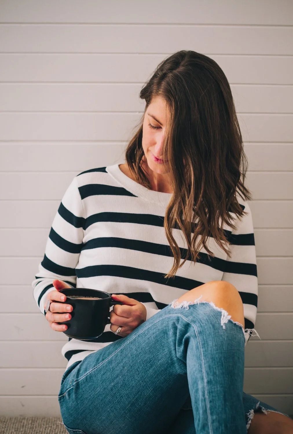 Woman resting quietly — representing the nervous system regulation and low-capacity support central to Capacity First Care™.