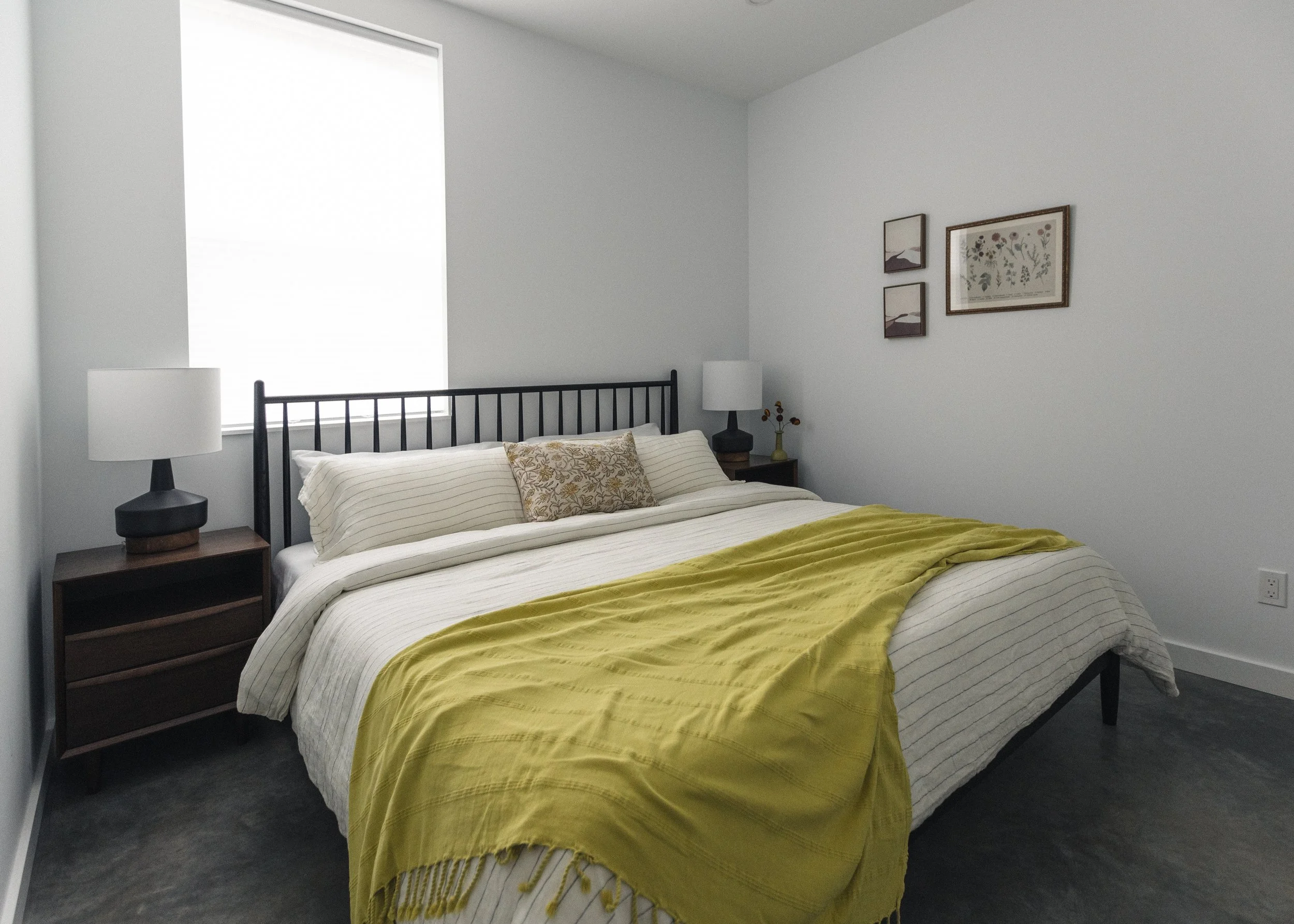 A neatly made bed with Canadian made Silk 'n' Snow flax linen and 100% cotton bedding, this room was expertly designed by Covet Interiors offering a minimalist style with a large window allowing natural light.