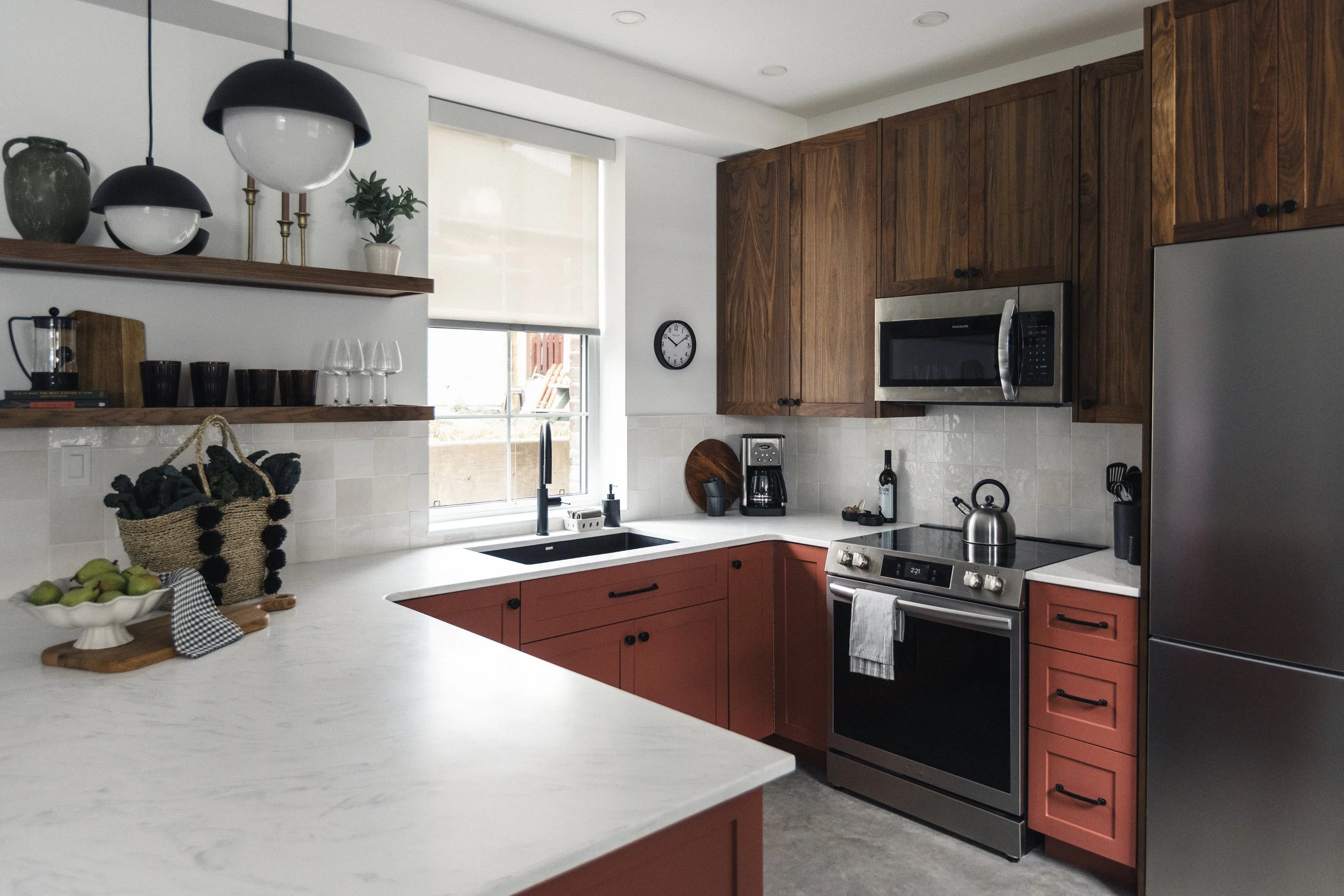 Modern kitchen with custom Walnut cabinetry, brand new stainless steel appliances, quartz countertops, private balcony and off street parking.