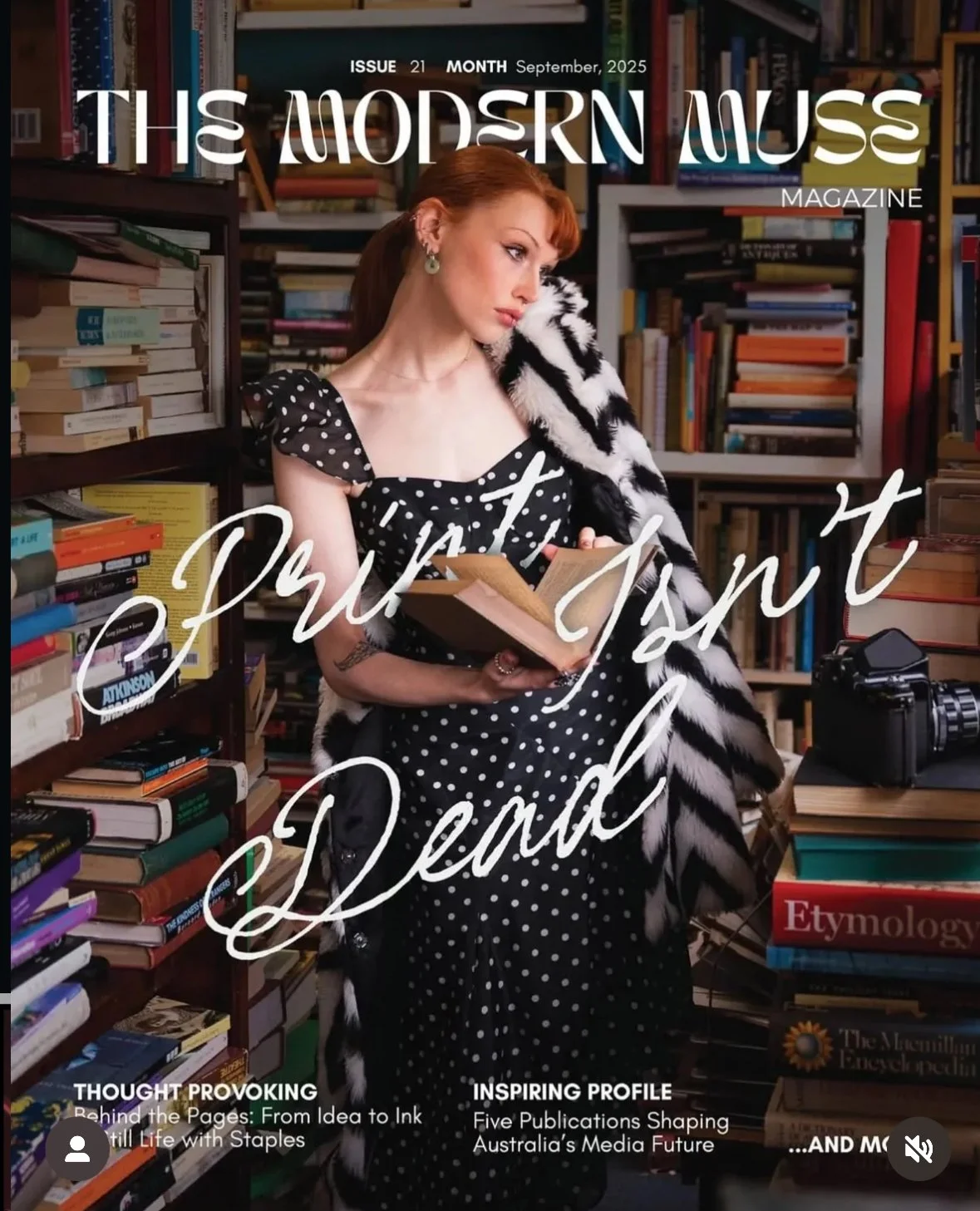 Magazine cover titled 'The Modern Muse', featuring a woman with red hair in a polka dot dress, surrounded by bookshelves and stacks of books in a bookstore or library setting, holding an open book.