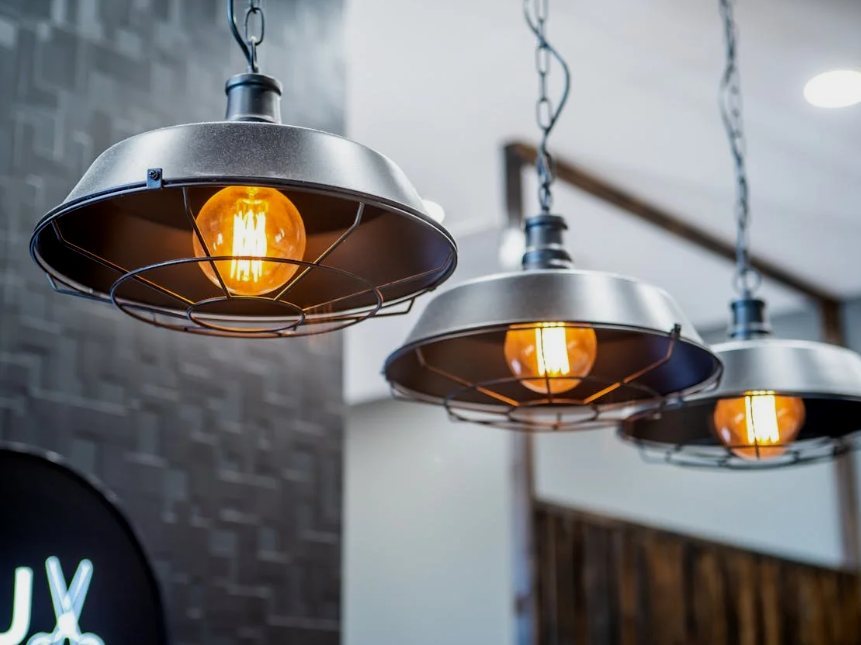 Three industrial-style pendant lights with exposed bulbs hanging from the ceiling.
