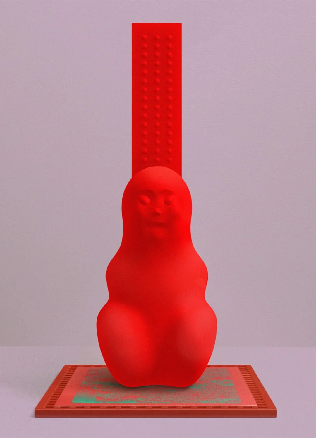 A red sculpture resembling a human face with a pillowy body, positioned on a flat surface.