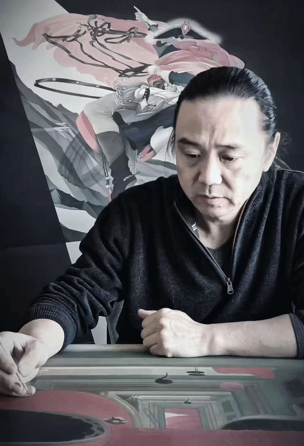 A man with black slicked-back hair wearing a black zip-up sweater, sitting at a table, looking down and touching a glass table in front of him, with a modern abstract painting of a woman hanging on a black wall behind him.