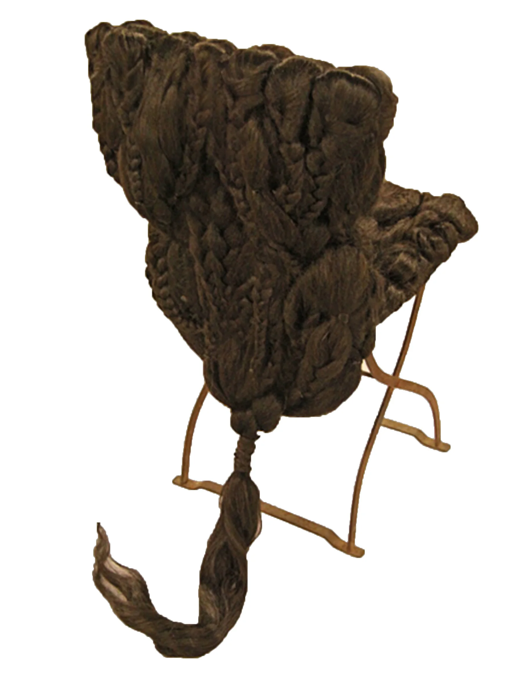 A vintage stuffed animal, possibly a dog, with a fluffy, textured body, sitting on a metal stand with curved legs.