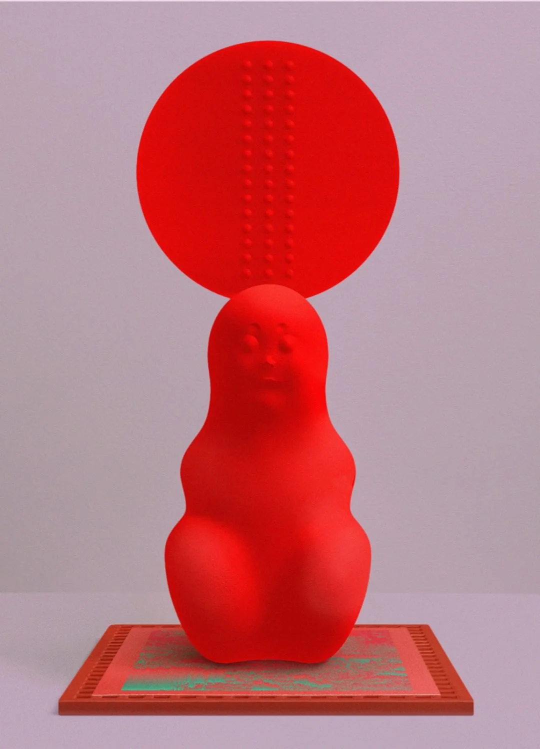 A red sculpture with a humanoid face at the base and an enlarged circular head with dotted lines, placed on a patterned orange base against a plain background.