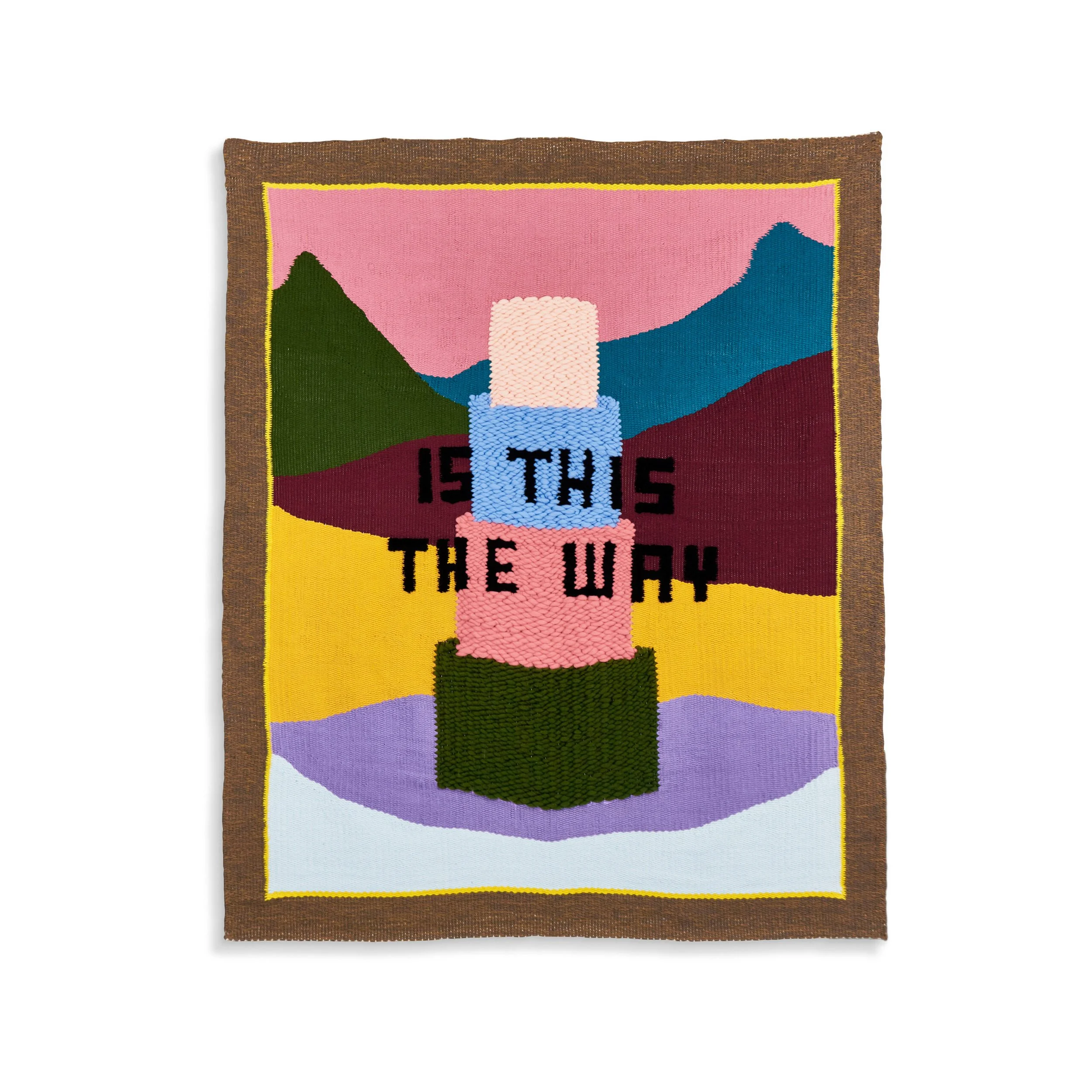 Colorful embroidered textile with a mountain scene, sunrise, and text 'The Way' at the bottom.
