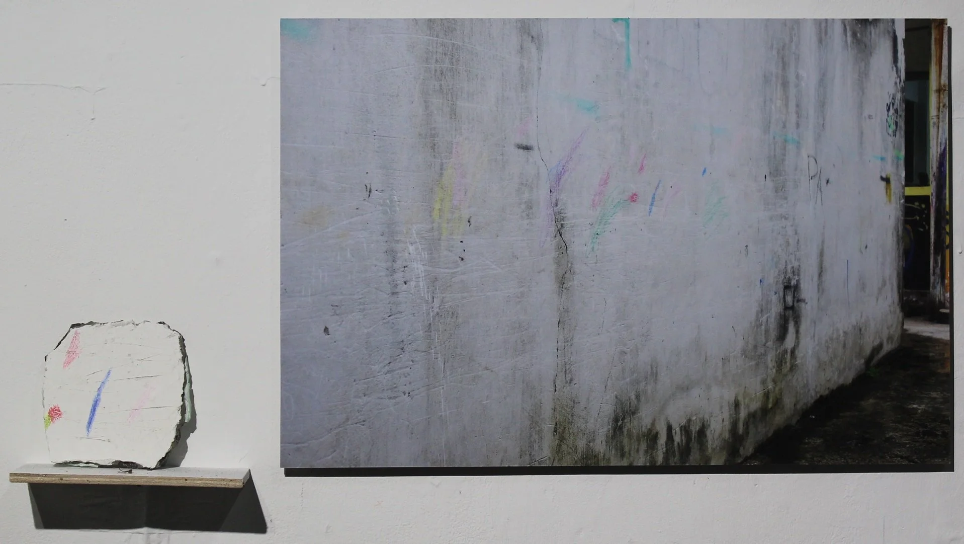  Souvenirs From A Lane Near Tirtodipuran Street 
 Pigment print on archival paper on aluminium | Cement, acrylic, sawdust and pencil on stone 
 42 cm x 63 cm | 14 cm x 13 cm, 2018 