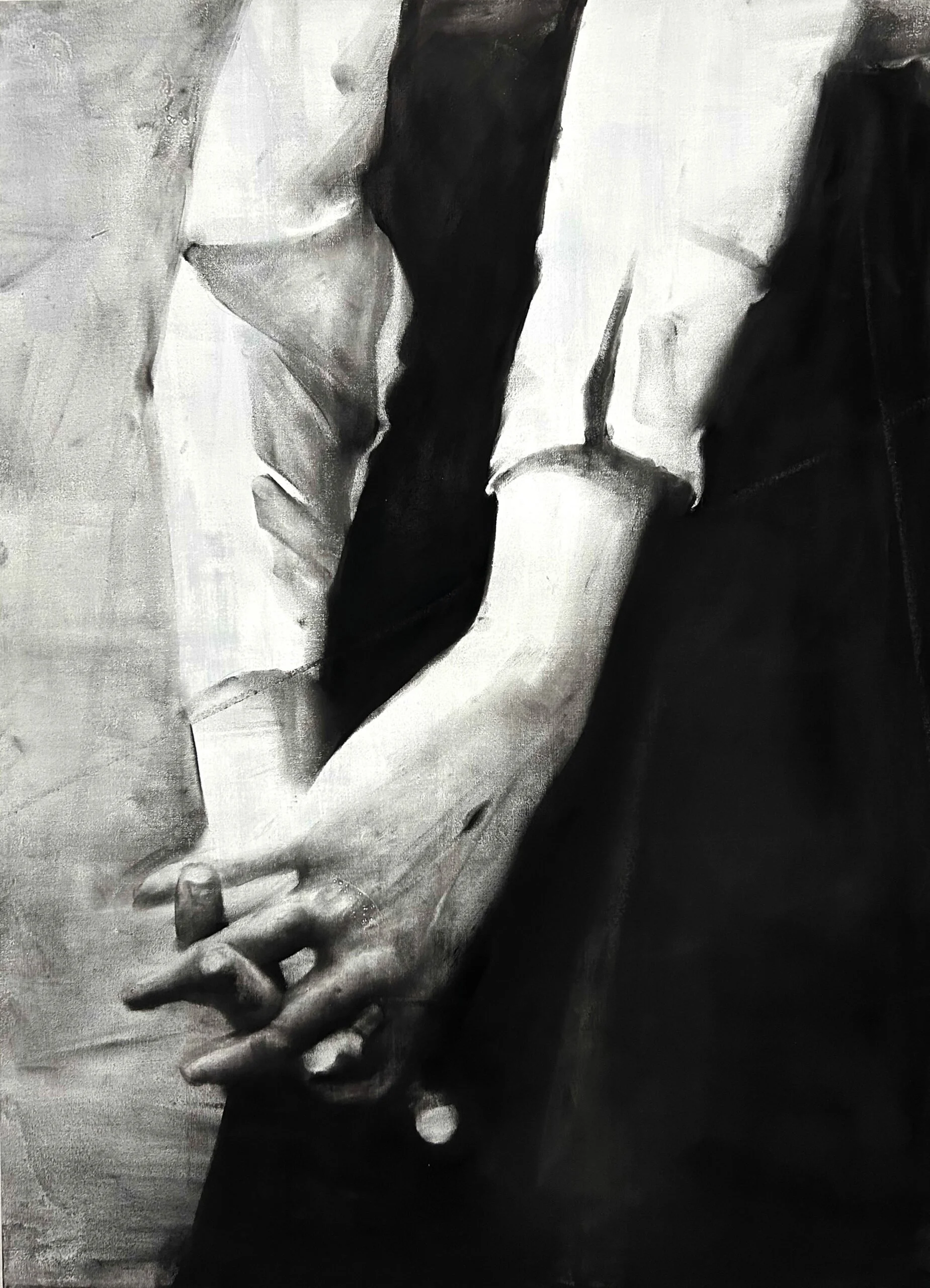 Close-up of two hands holding each other, painted in black and white.